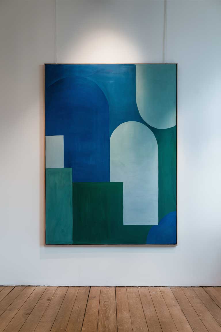 A large, minimalist abstract painting hanging on a white wall. The painting should feature various shades of blue and green in simple, geometric shapes.