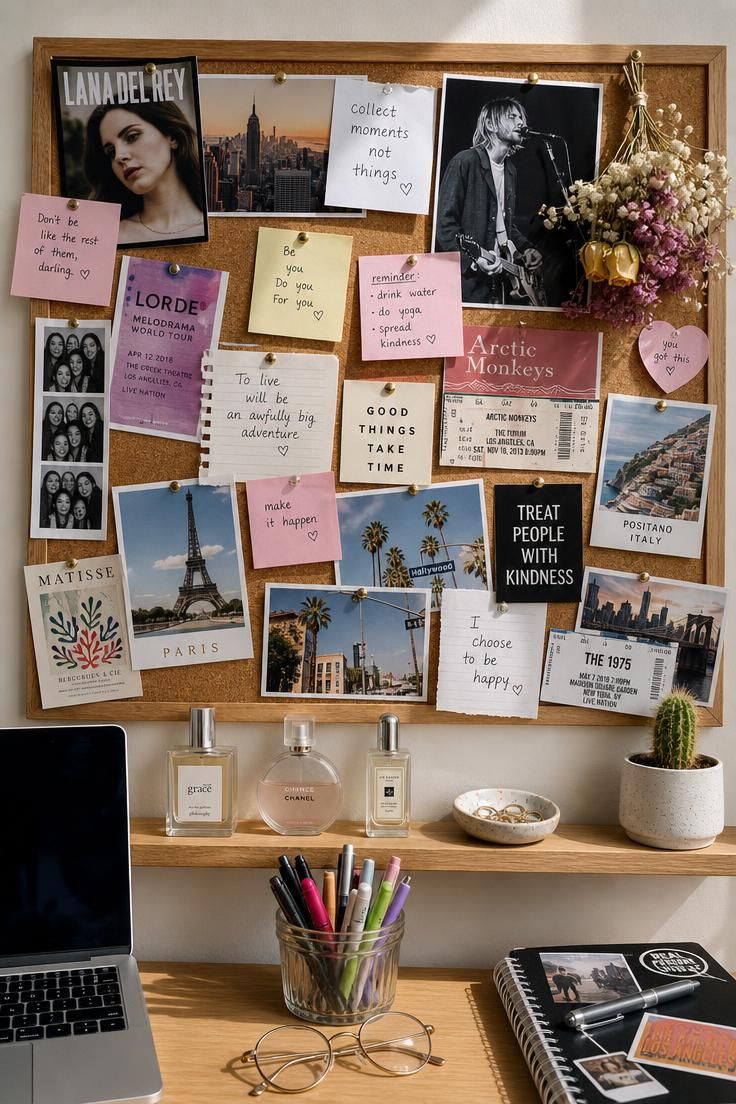 Large cork pinboard collage with magazine cutouts, dried flowers, postcards, and perfume bottles on a ledge shelf below