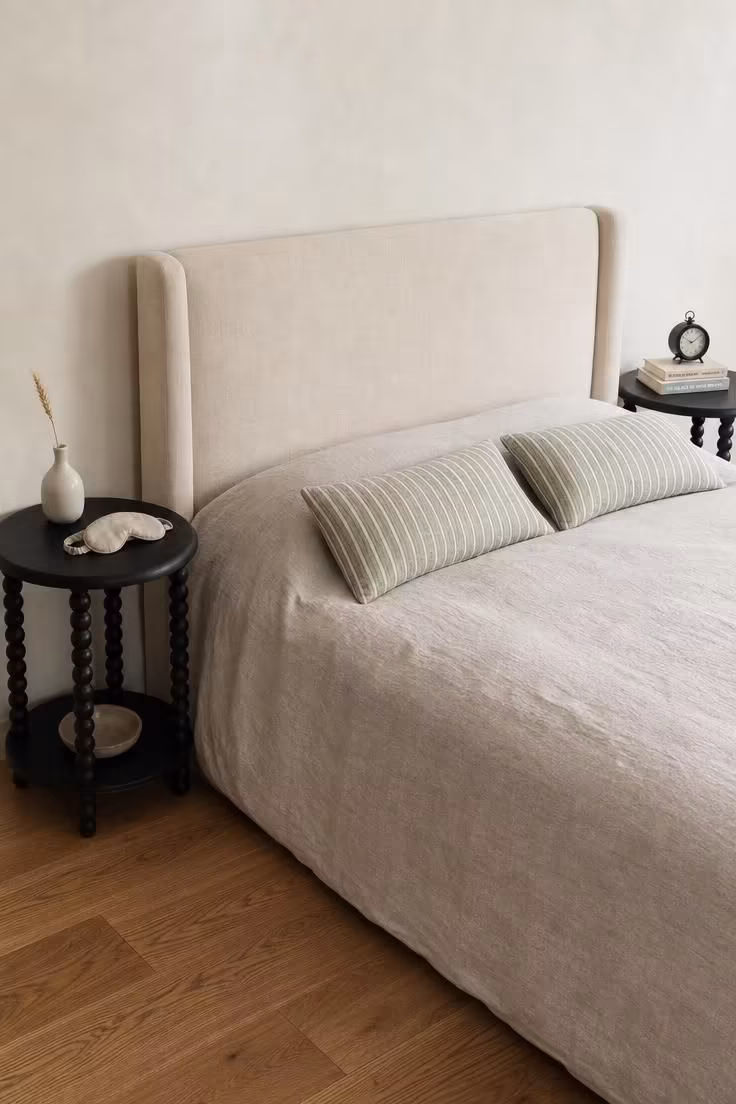 13 Cozy Bedroom Ideas With Black Furniture for Any Style 9 Pair of black spindle-leg nightstands flanking a cream upholstered headboard with soft linen bedding in diffused light