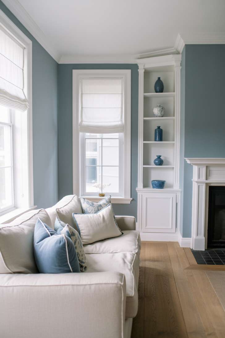 31 Fresh Blue and White Living Room Ideas That Inspire 7 Light blue walls with white trim and sectional sofa