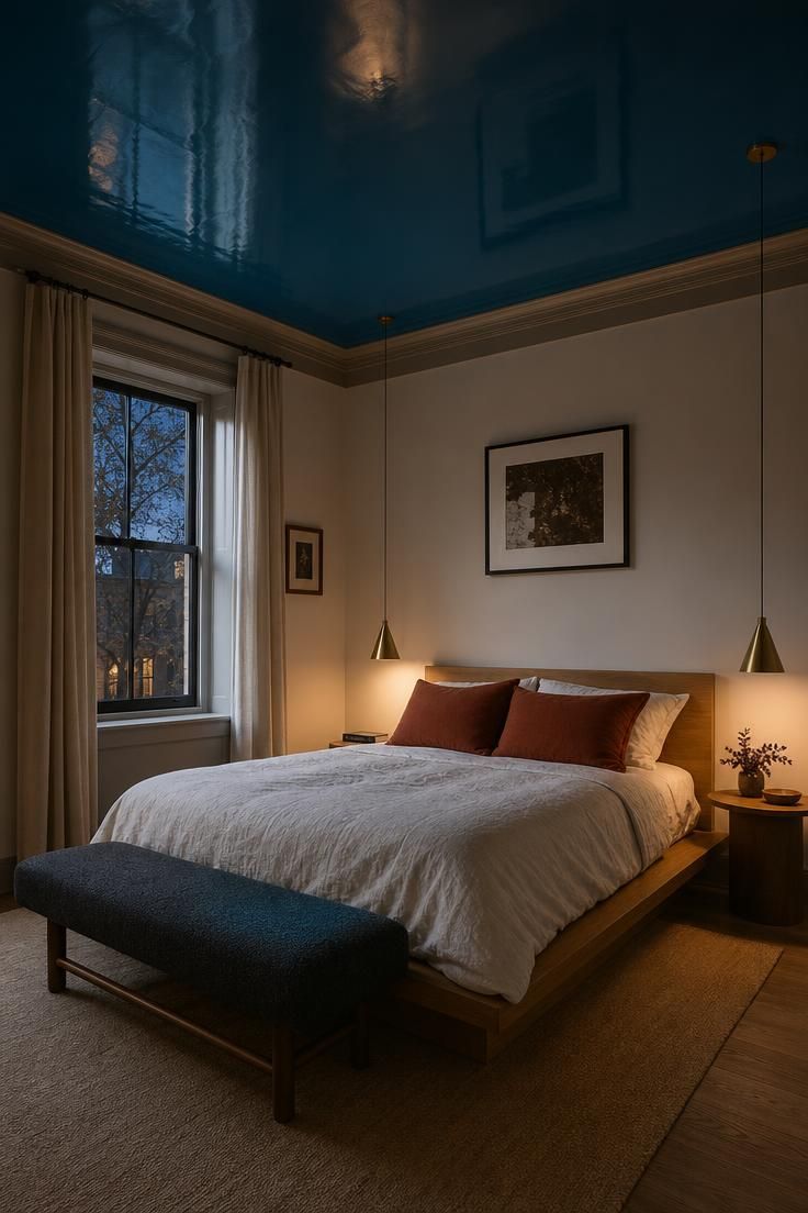 14 Colorful Eclectic Home Ideas for a Joyful Space 7 Bedroom with a glossy peacock blue ceiling above a pale walnut bed and brass pendant lights.