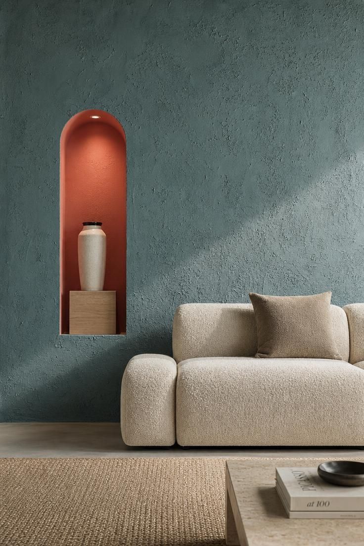 14 Colorful Eclectic Home Ideas for a Joyful Space 11 Smoky teal plaster wall with a coral alcove holding a cream stoneware vessel.