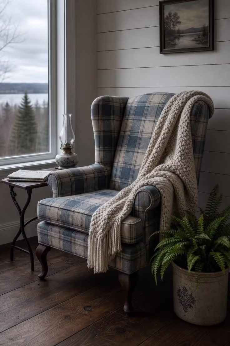 12 Cozy Cottage Farmhouse Living Room Ideas Worth Saving 10 Chunky knit throw draped over a faded blue plaid wingback chair in a cottage farmhouse living room with cool overcast light