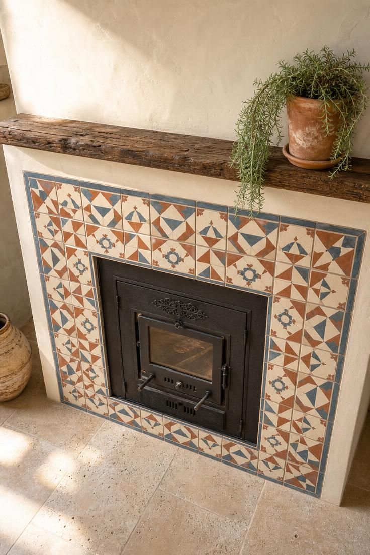 11 Cottage Fireplace Ideas That Feel Warm and Lived-In 4 Hand-painted encaustic tiles in terracotta and slate blue framing a cast-iron firebox insert in bright midday light