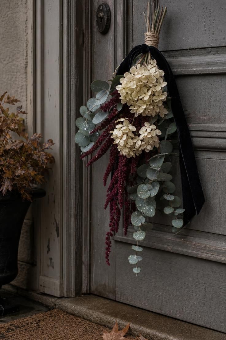 6 Fall Door Decorations That Already Feel Overdone—and What to Try Instead 2 Close-up of an asymmetrical fall swag with cream hydrangea and burgundy amaranth.