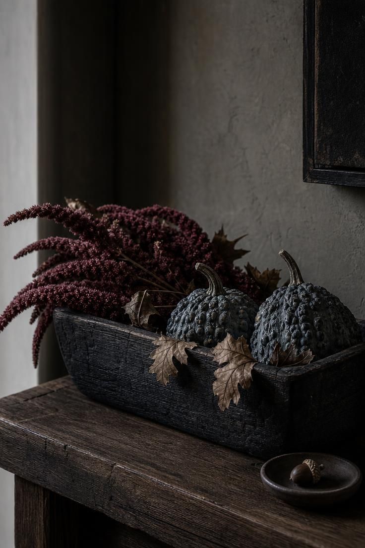 11 Cozy Fall Fireplace Mantel Decorating Ideas for Warmth 2 Charred cedar trough with wine-red amaranthus and warty blue-gray gourds on a moody fall mantel.