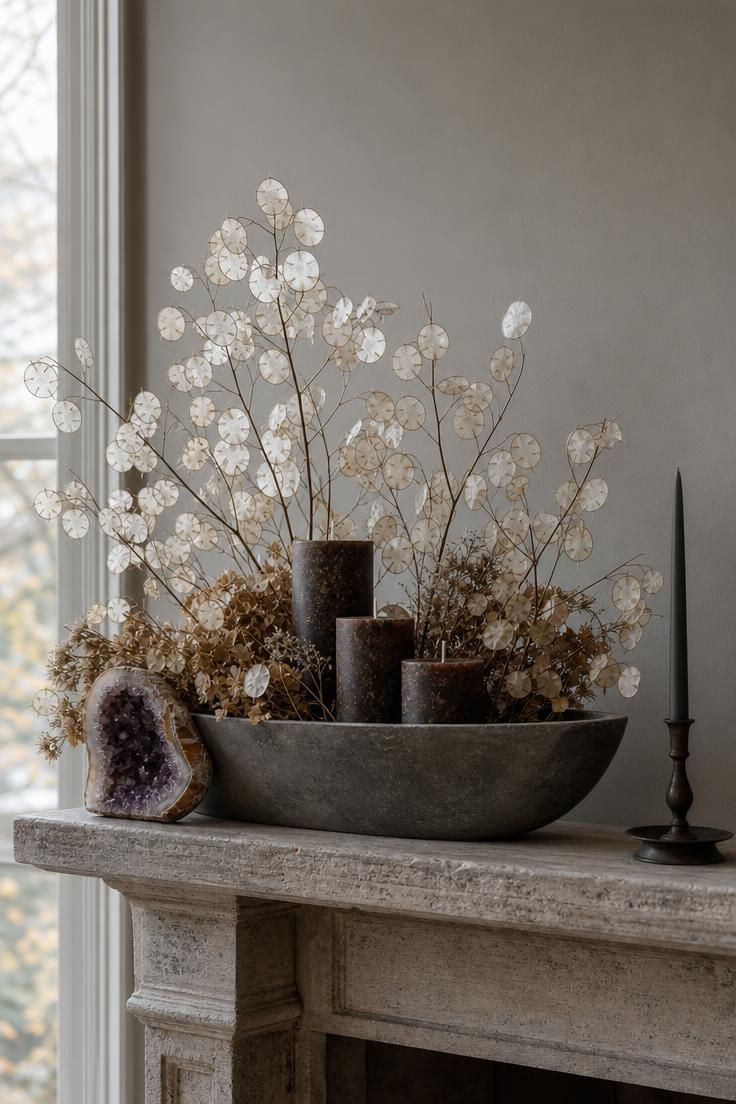 11 Cozy Fall Fireplace Mantel Decorating Ideas for Warmth 5 Long slate-gray stoneware bowl with dried lunaria and smoked birch candles on a quiet fall mantel.