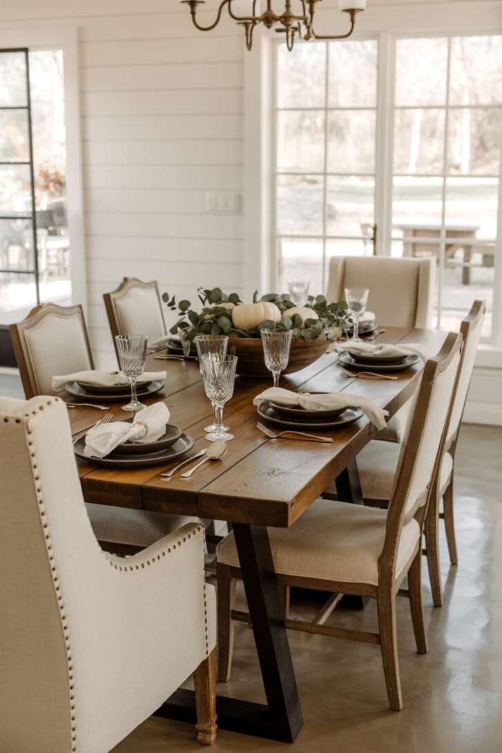 Modern farmhouse dining room with reclaimed wood table and black metal legs