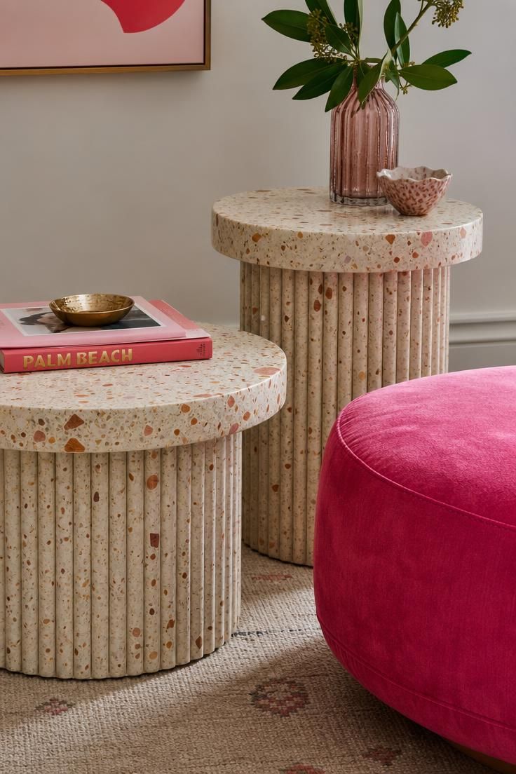 11 Playful Funky Eclectic Decor Ideas for Fearless Rooms 9 Cream and rust terrazzo side tables beside a hot pink velvet ottoman on pale oak flooring.