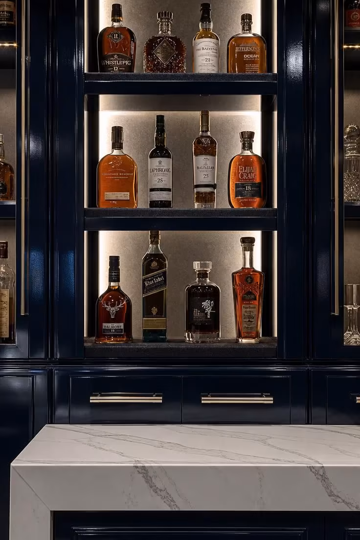 13 Stylish Game Room Ideas for Adults to Lounge and Play 12 Navy lacquered bar wall with backlit bottle display and felt-lined shelves.