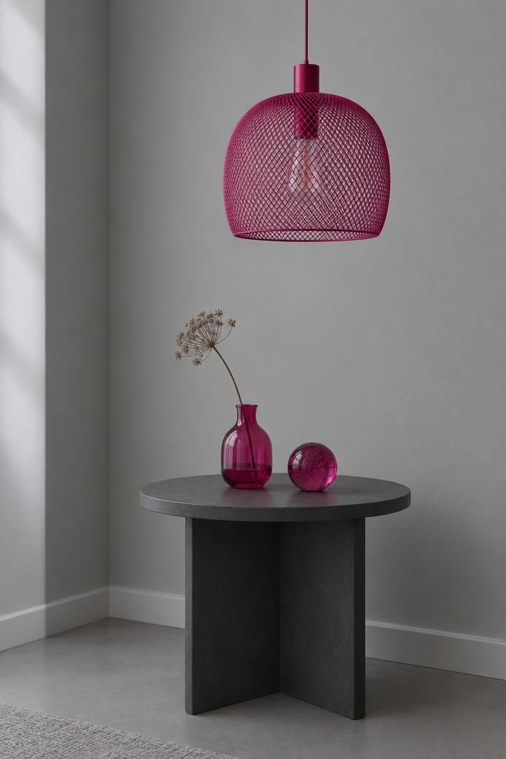 13 Bold Gray Bedroom Ideas with Pop of Color for Cheer 12 Corner vignette with a fog gray wall, a fuchsia mesh pendant above a charcoal side table, and fuchsia glass objects on the table's surface.
