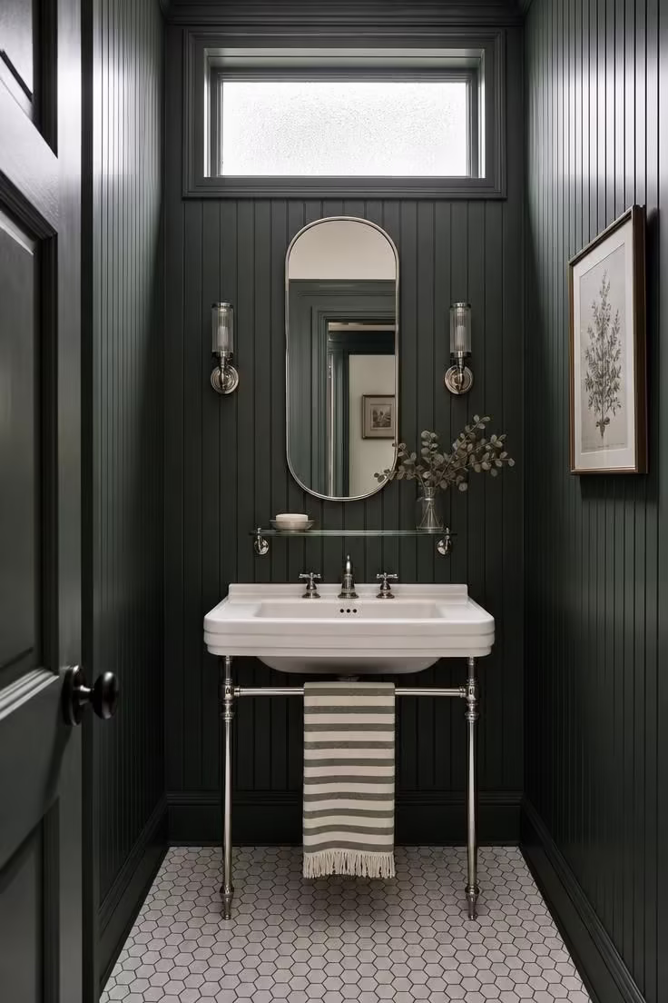 13 Lush Green Powder Room Ideas That Feel Like a Retreat 2 Hunter green beadboard powder room with a white porcelain console sink on polished nickel legs and hexagonal marble floor