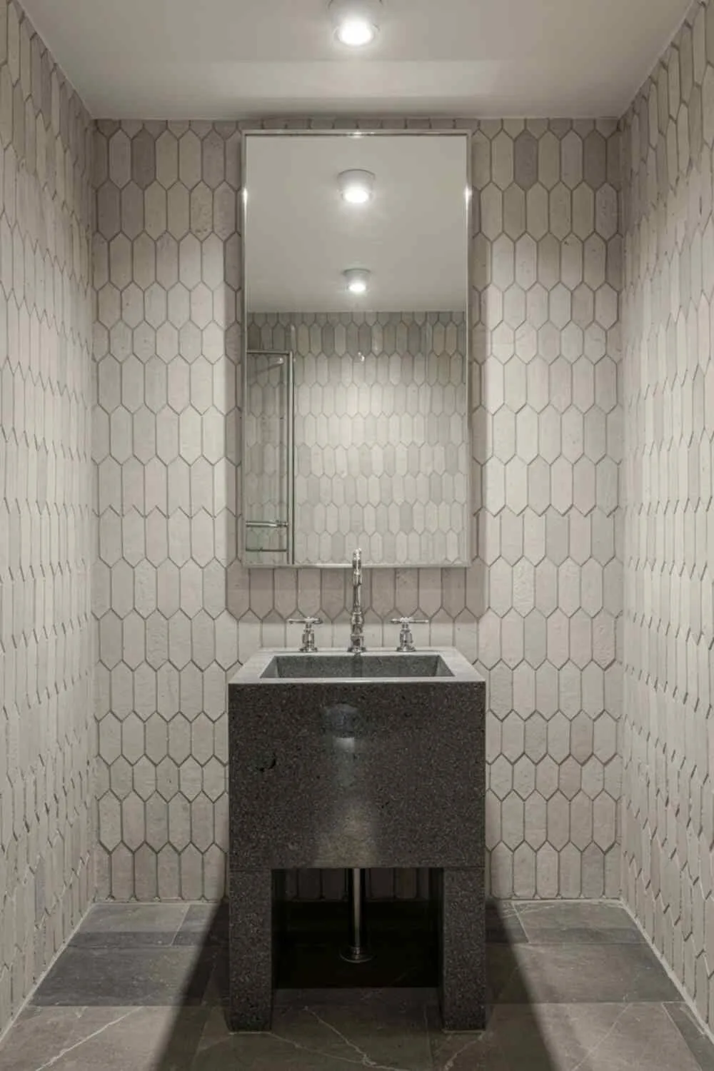 23 Gorgeous Grey Bathroom Ideas for a Stylish Upgrade 23 A minimalist grey bathroom with black granite sink, brushed nickel framed mirror, and hexagonal tiles