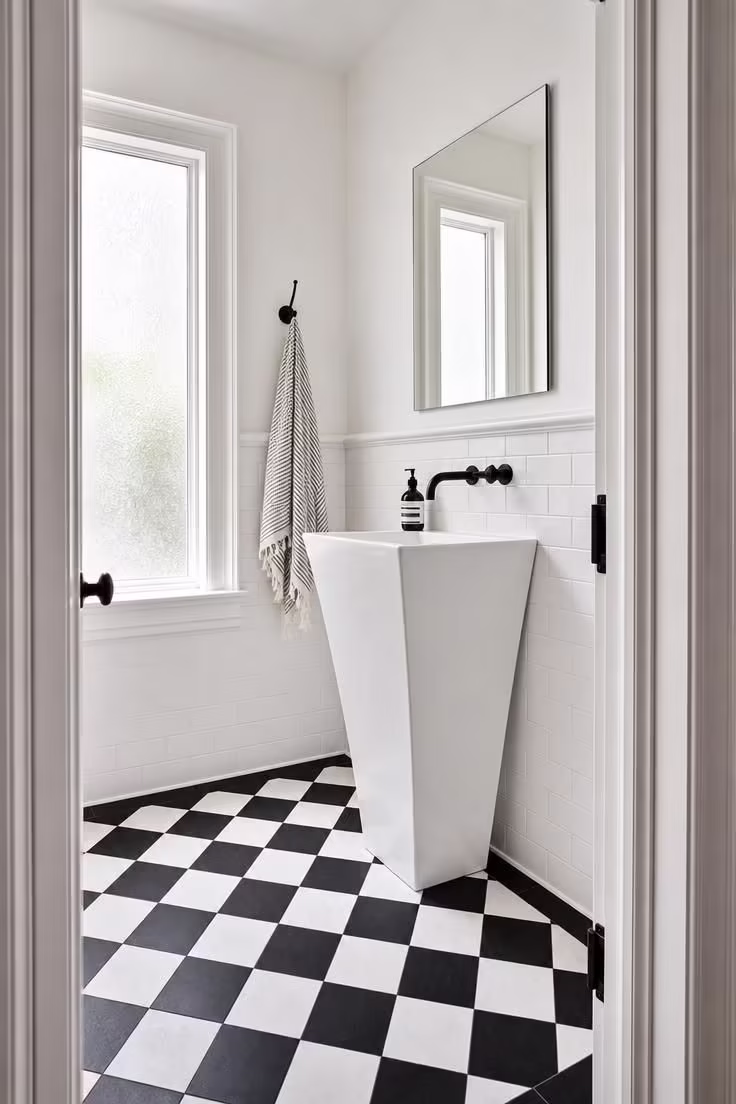 10 Half Bathroom Ideas With Pedestal Sink Worth Copying 2 Modern slim pedestal sink on black-and-white checkered cement tile in a bright half bathroom