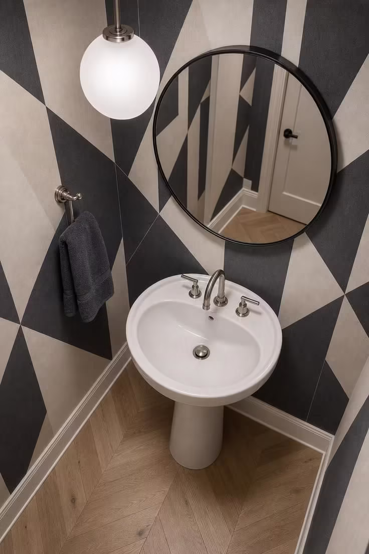 10 Half Bathroom Ideas With Pedestal Sink Worth Copying 5 Overhead view of a compact round pedestal sink with charcoal and cream geometric wallpaper