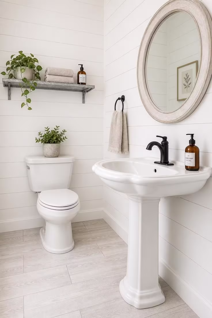 10 Half Bathroom Ideas With Pedestal Sink Worth Copying 8 Farmhouse pedestal sink with shiplap walls and a galvanized metal shelf holding towels and a plant