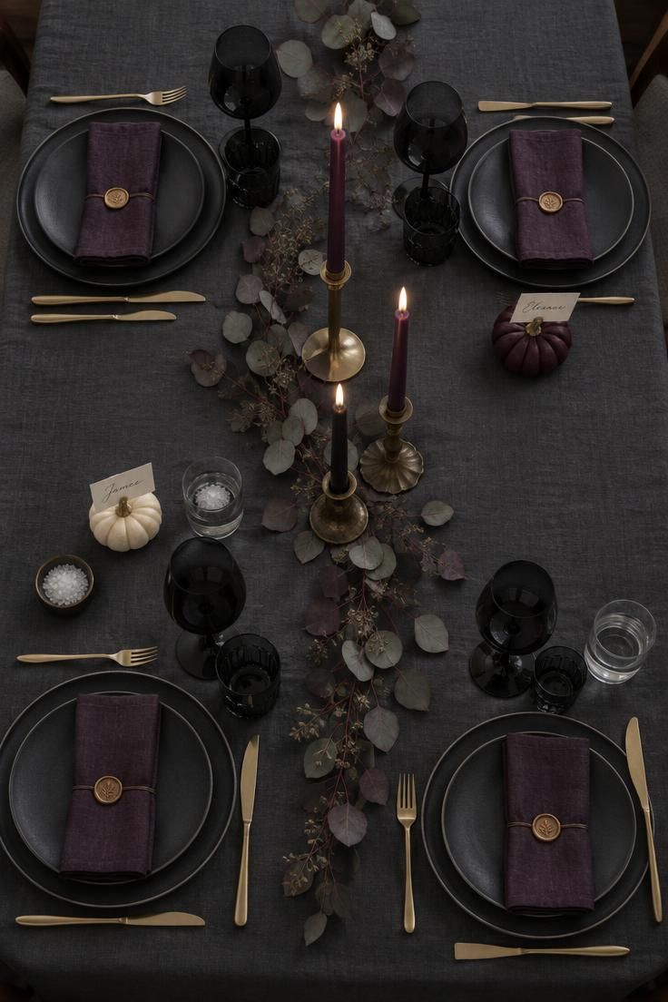 13 Cozy Halloween Aesthetic Ideas for a Warm Autumn Home 12 Overhead view of a dark dining table with taper clusters, mini pumpkins, and eucalyptus.