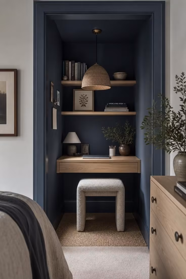 13 Cozy Home Office Ideas for Small Spaces You'll Love 2 A slate blue closet turned home office alcove with the bifold doors removed and a narrow white oak desk.