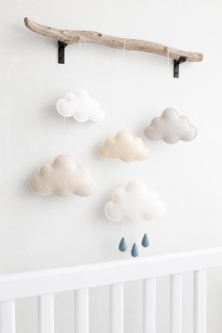 10 Playful Kids Room Wall Decor Ideas for Cozy Spaces 8 Felt cloud mobile hanging from a driftwood branch bracket on a white nursery wall in soft diffused light