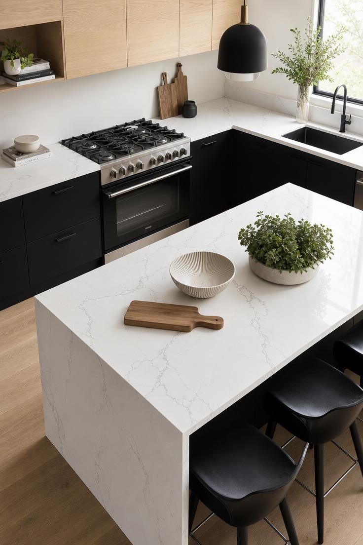 13 Fresh Kitchen Color Palette Ideas to Try This Year 9 Black lower cabinets with white oak uppers and a waterfall quartz island in a modern kitchen.