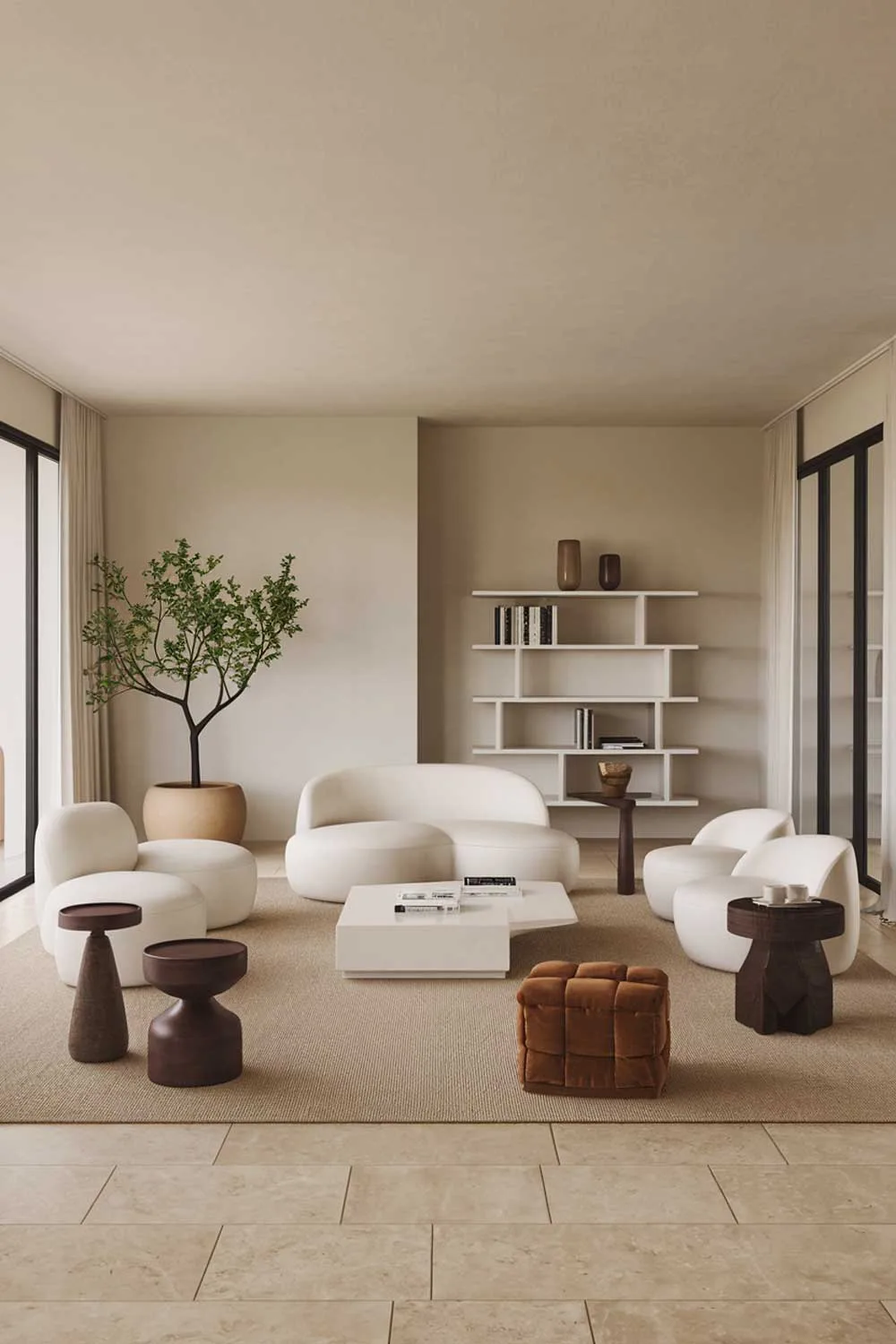 25 Inspiring Minimalist Living Room Ideas with Earth Tones 11 A modern white minimalist living room with earth tones. The room features a white sofa, a few white chairs, and a white coffee table. There are also two white bookshelves. The walls are painted beige. The floor is made of beige tiles. A potted plant with green leaves and a few decorative objects with earth tone colors - a beige rug, a dark brown wooden stool, a dark brown wooden side table, and a few dark brown decorative items. The room has large windows with white curtains.