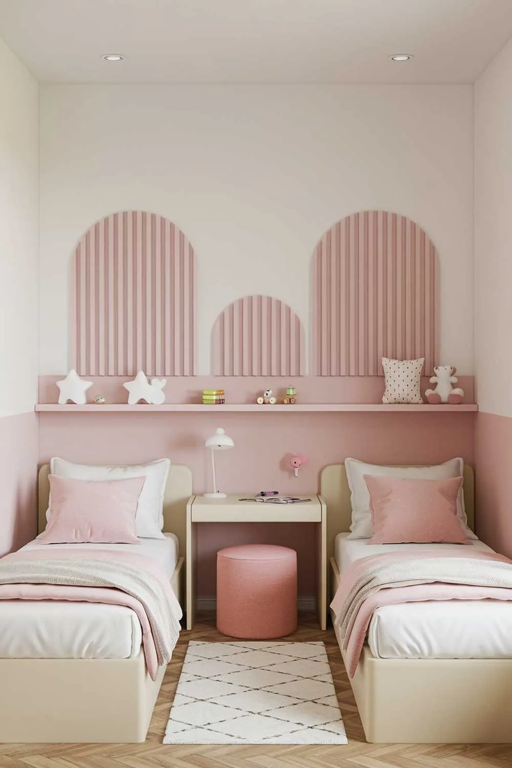 29 Minimalist Kids Bedroom Ideas: Simple Yet Playful Designs 20 A minimalist kids bedroom design with a shared room for two girls. The room has two single beds with white sheets and pink pillows. There's a small desk between the beds with a desk lamp. On the wall above the bed is a decorative pink and white striped pattern. Below the decor is a shelf with a few toys. The floor is covered with a white rug. The room has a few pink and white decor items. The room has a wooden floor.