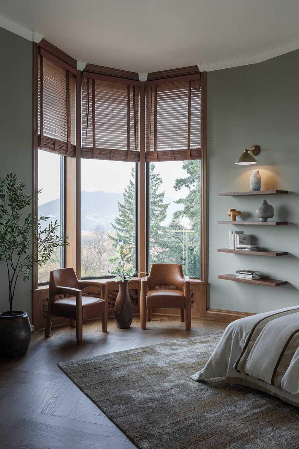 A modern luxury bedroom decor with a highly detailed design. The room has a large window with wooden blinds, revealing a serene landscape of trees and mountains. The walls are painted a soft gray, complementing the wooden elements in the room. The bed is positioned near the window, with a plush rug beneath it. A pair of wooden chairs is placed near the window. The room has a few decorative items, including a potted plant, a lamp, and a wall-mounted shelf with a few books and a vase. The floor is made of wooden planks.