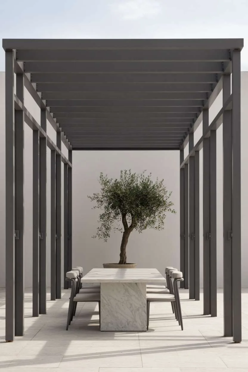 27 Stunning Modern Pergola Design Ideas for Stylish Shade 27 Minimalist dark grey steel pergola with flat roof over white marble table and modern chairs with olive tree accent