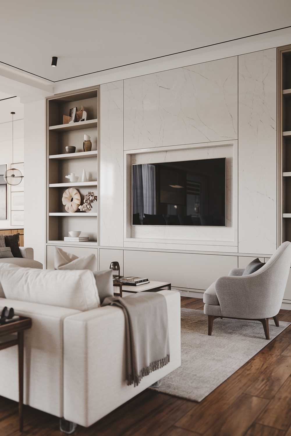 A large modern Scandinavian living room decor with a TV wall. The room features a white sofa with a few throw pillows, a gray armchair, and a coffee table. The wall has a built-in TV and a few shelves with decorative items. The floor is made of wood.