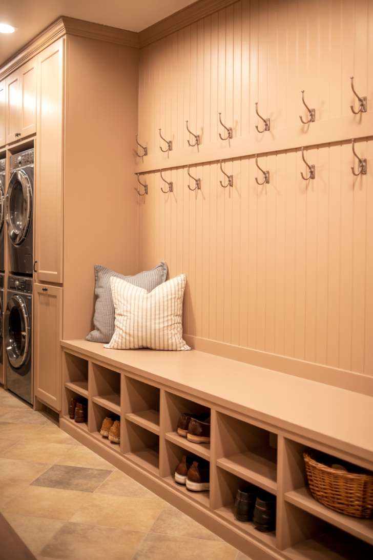 13 Bold Mudroom Laundry Room Ideas for a Stylish Space 7 Built-in mudroom bench with deep shoe cubbies, double-height hooks, and a striped linen cushion