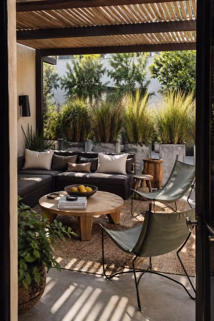 Eclectic patio furniture mix with modular sofa and sculptural metal accent chairs on concrete