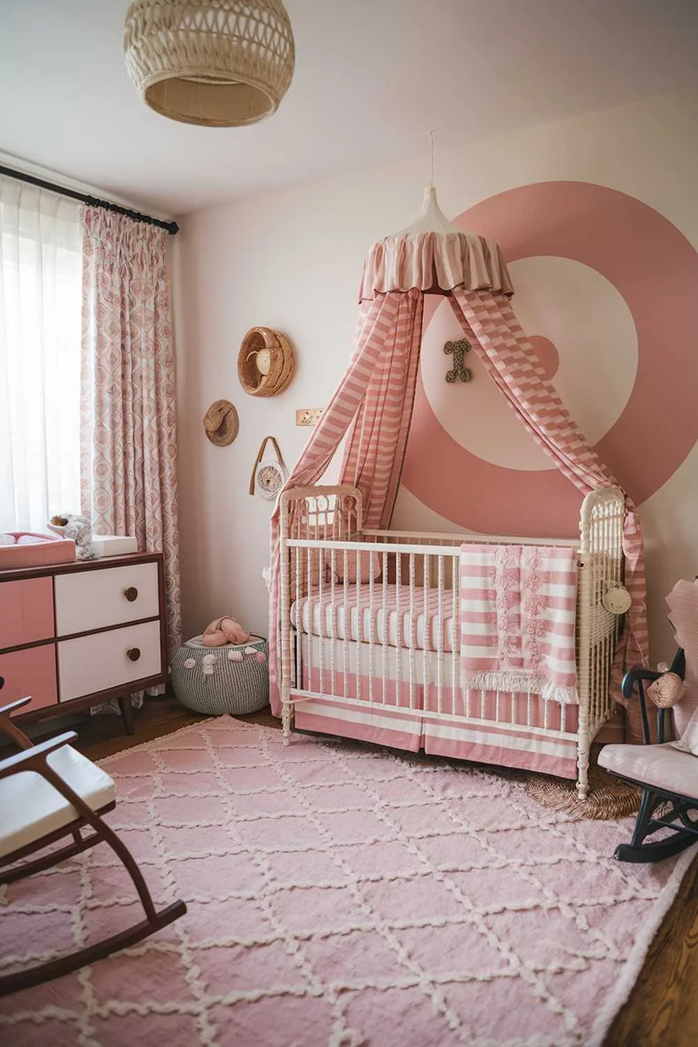 A cozy and stylish pink boho nursery room decor with a highly detailed design. The room features a vintage-style crib with a pink and white striped bedding. There is a vintage-style rocker near the crib. The room has a pink and white patterned rug. There is a wooden dresser with pink and white drawers. The walls are adorned with decorative items, including a large pink and white circle pattern. The room has a patterned curtain.