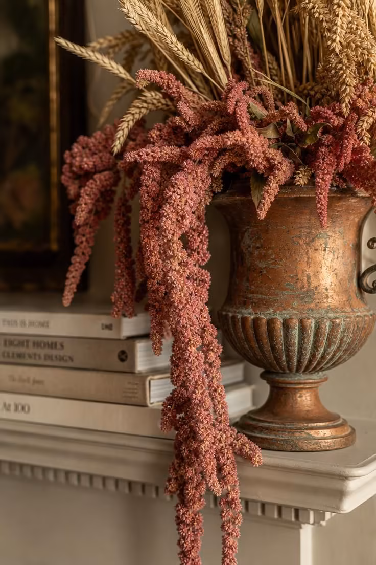 10 Dreamy Pink Fall Decor Ideas for a Cozy Autumn Home 10 Blush pink amaranthus and dried wheat stalks arranged in a copper urn on a fireplace mantel.