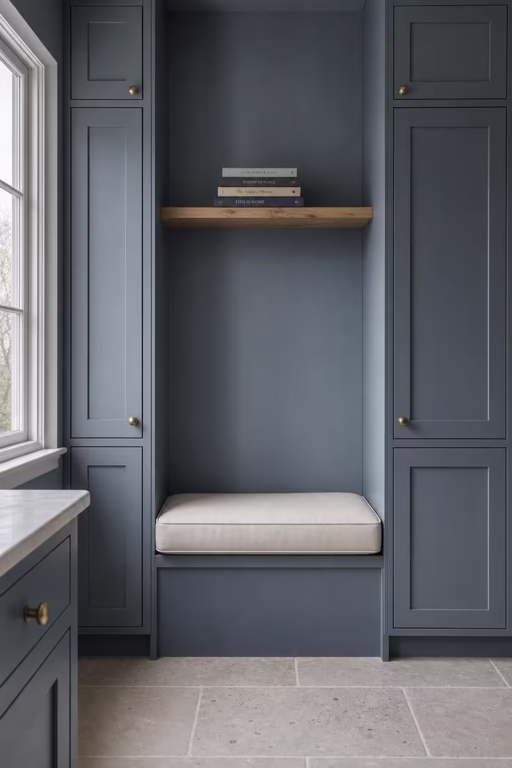 12 Cozy Reading Nook in Kitchen Ideas That Feel Like Home 2 Slate blue reading alcove with cream cushion tucked between tall kitchen pantry cabinets