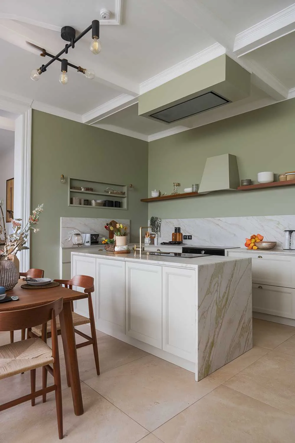 19 Sage Green Kitchen Ideas for a Stylish Refresh 13 Contemporary kitchen with sage green accent wall, white island, and wooden dining set