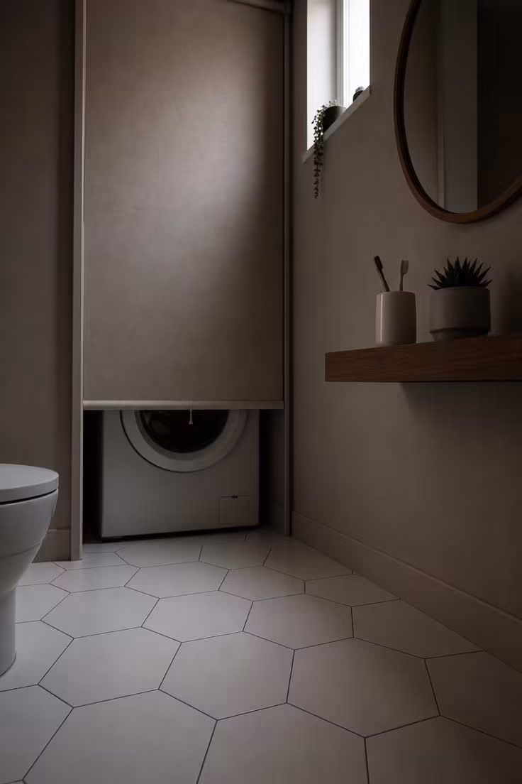 Porcelain hexagon floor tile leading to a concealed washer behind a dove-toned linen roller blind