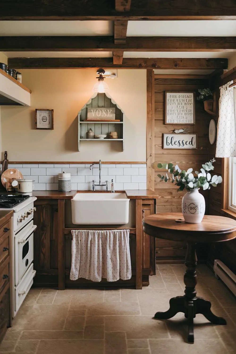 21 Small Farmhouse Kitchen Ideas for Country Style Comfort 9 A small farmhouse kitchen with wooden beams, a white sink, and a stove. On the wall above the sink, there's a decorative shelf with a few items. The floor is covered with beige tiles. There's a round wooden table in the corner, and on it, there's a white vase with some greenery. The room has a few other decorations, including a sign that says "Blessed". The lighting is warm and inviting.