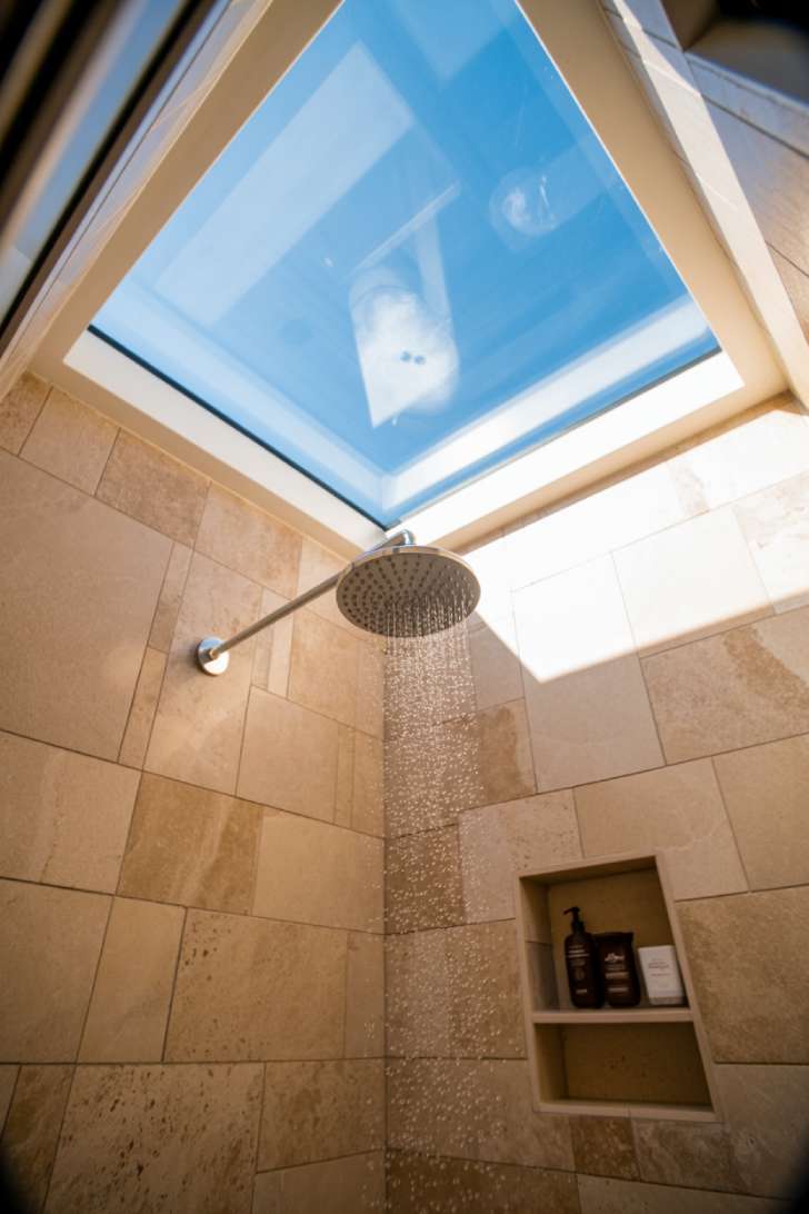 13 Smart Tiny House Bathroom Ideas for Tiny Budgets 6 Overhead skylight flooding natural light into a tiny house shower
