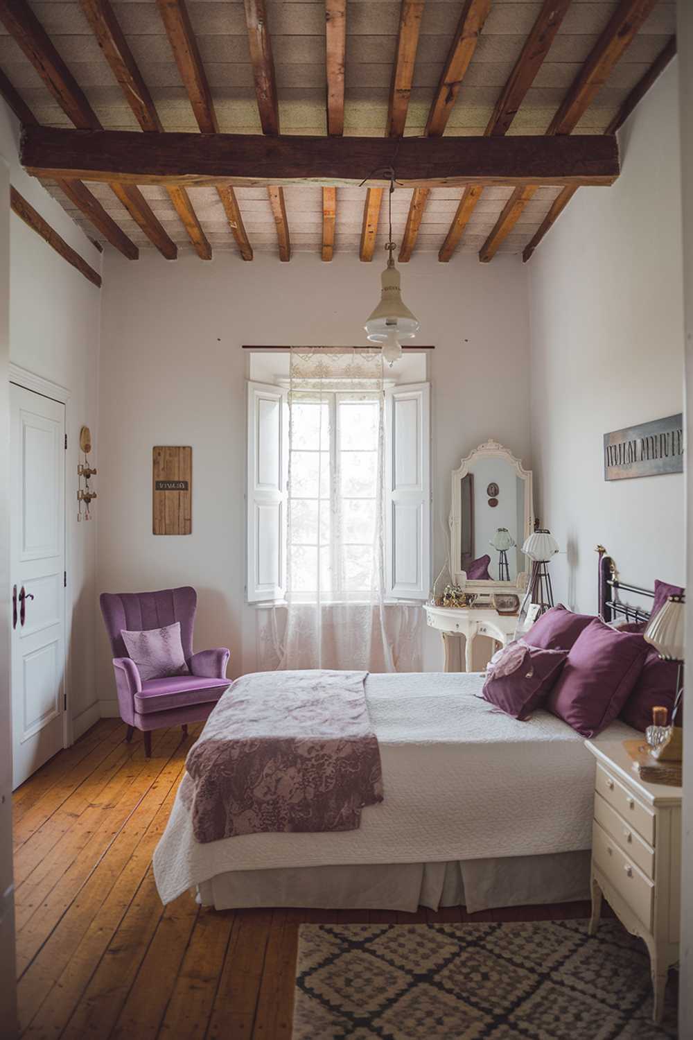 Stylish farmhouse bedroom with wooden beam ceiling, white duvet, and purple accent pieces creating visual interest