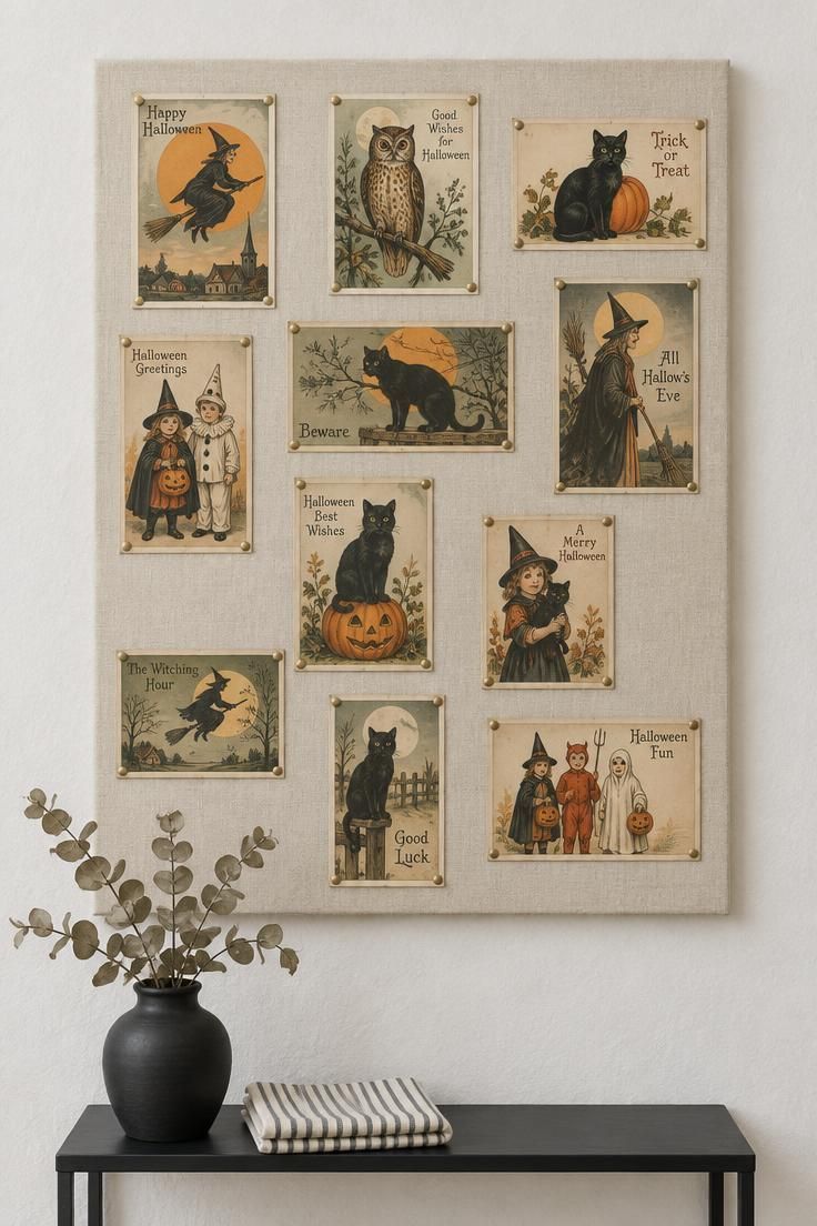 13 Charming Vintage Halloween Decor Ideas for Warmth 2 Cream linen board on a pale wall displaying an irregular grid of antique-style Halloween postcards pinned with brass tacks.