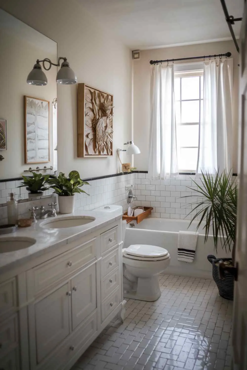 17 White Bathroom Ideas for a Fresh, Stylish Space 12 White bathroom featuring double-sink vanity, toilet, bathtub, white tile floor, wall art, potted plant, lampshade, and window with white curtains