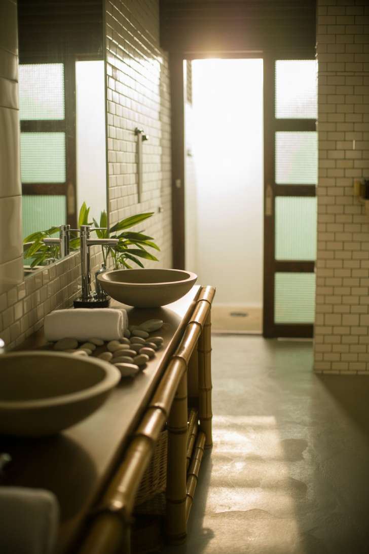 Japanese bathroom with white subway tiles and polished concrete floors