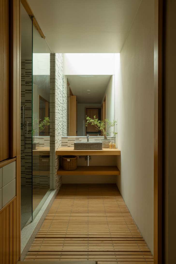 Modern Japanese bathroom with frameless glass shower panels and bamboo flooring